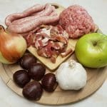 Photo of the trimmings box which includes sausage meat, chipolata sausages, bacon lardons, onion, chestnuts, garlic and bramley apple.