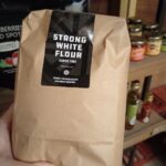 Photograph of a 1.5kg bag of Strong White flour produce by Norfolk and Better